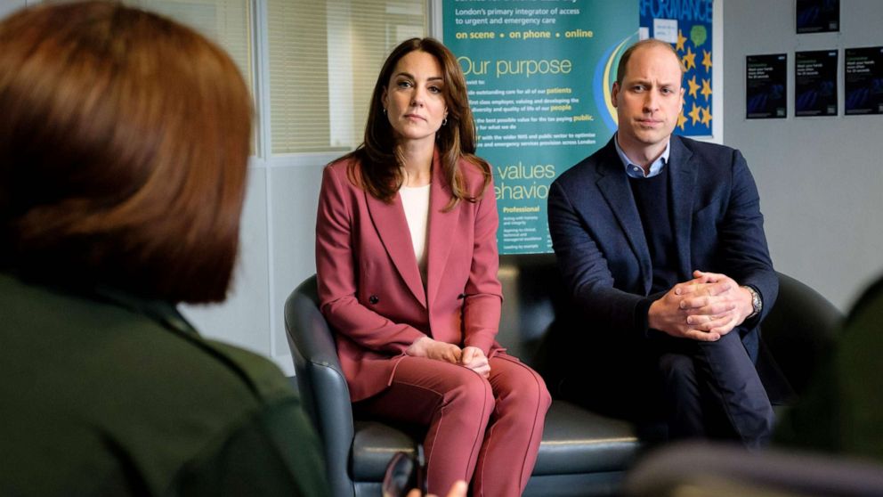 PHOTO: A handout photograph released by Kensington Palace on March 20, 2020, shows Britain's Prince William, Duke of Cambridge and Britain's Catherine, Duchess of Cambridge, during their visit to a London Ambulance Service control room south of London.
