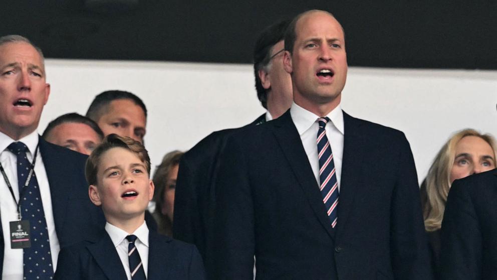 PHOTO: British businesswoman Debbie Hewitt, Britain's Prince George of Wales and Britain's Prince William sing the national anthem ahead of the UEFA Euro 2024 final football match between Spain and England at the Olympiastadion in Berlin on July 14, 2024.