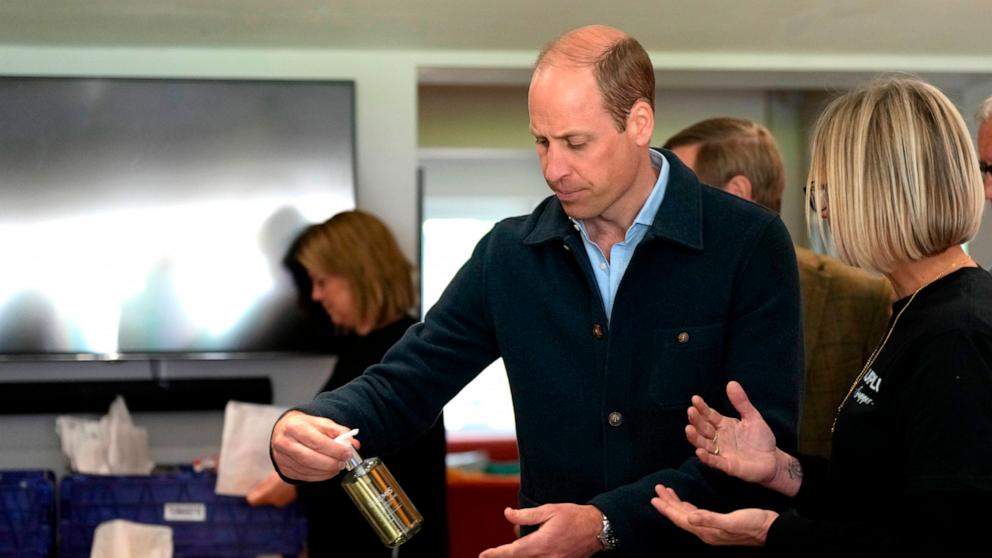 PHOTO: Prince William, Prince of Wales is shown items by Claire Hopkins, Operations Director, right, during a visit to Surplus to Supper, in Sunbury-on-Thames on April 18, 2024 in Surrey, England.