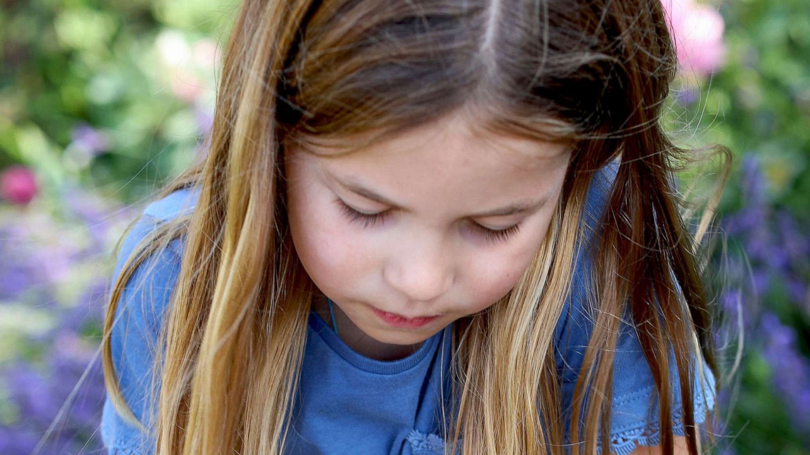 PHOTO: Britain's Princess Charlotte holds a red admiral butterfly in Norfolk, England, as part of the Big Butterfly Count initiative which is taking place across the UK.