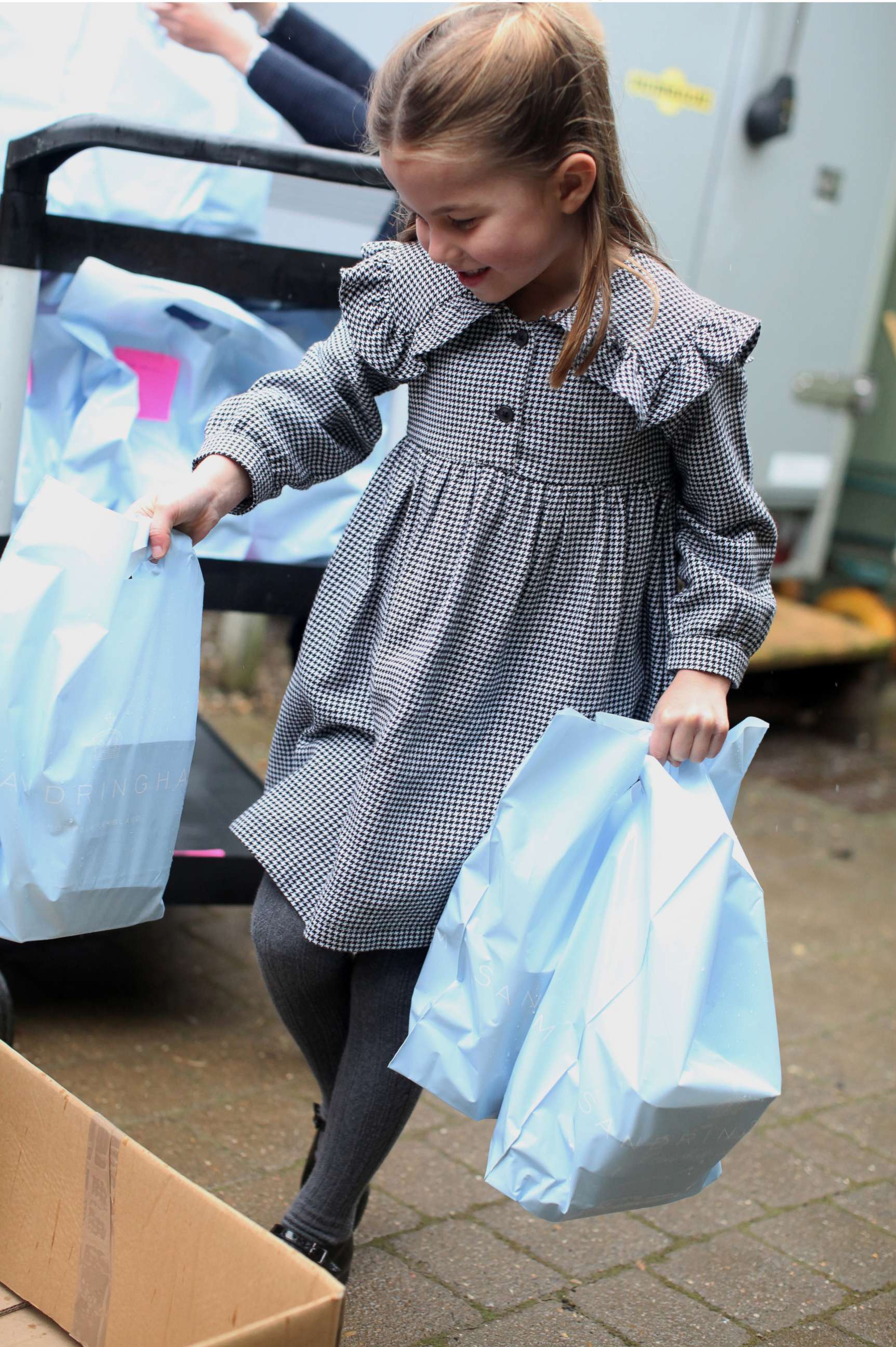 PHOTO: Princess Charlotte helps to pack up and deliver food packages for isolated pensioners in the local area along with her family.