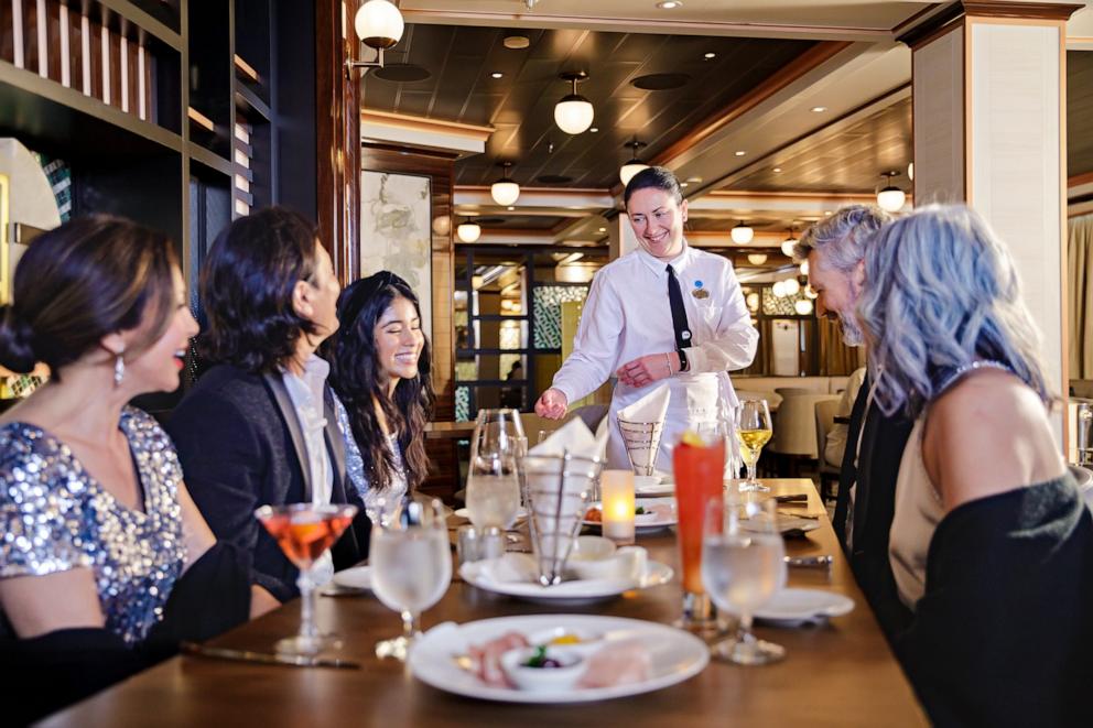 PHOTO: In this photo released by Princess Cruises, a member of the wait staff serves customers.