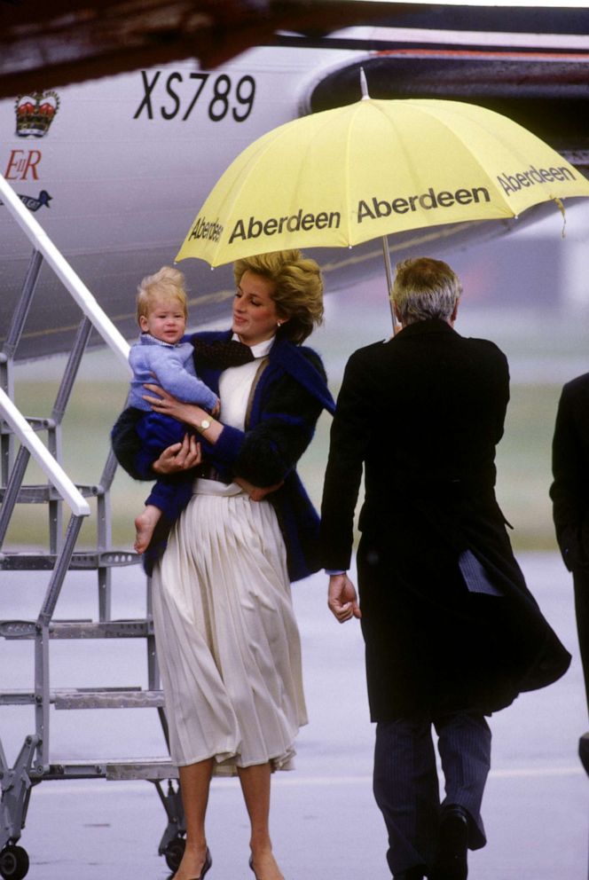 PHOTO: Diana Princess of Wales carries a baby Prince Harry from the Queens Flight aircraft, Sept. 23, 1985, upon arrival at Aberdeen airport in Scotland.