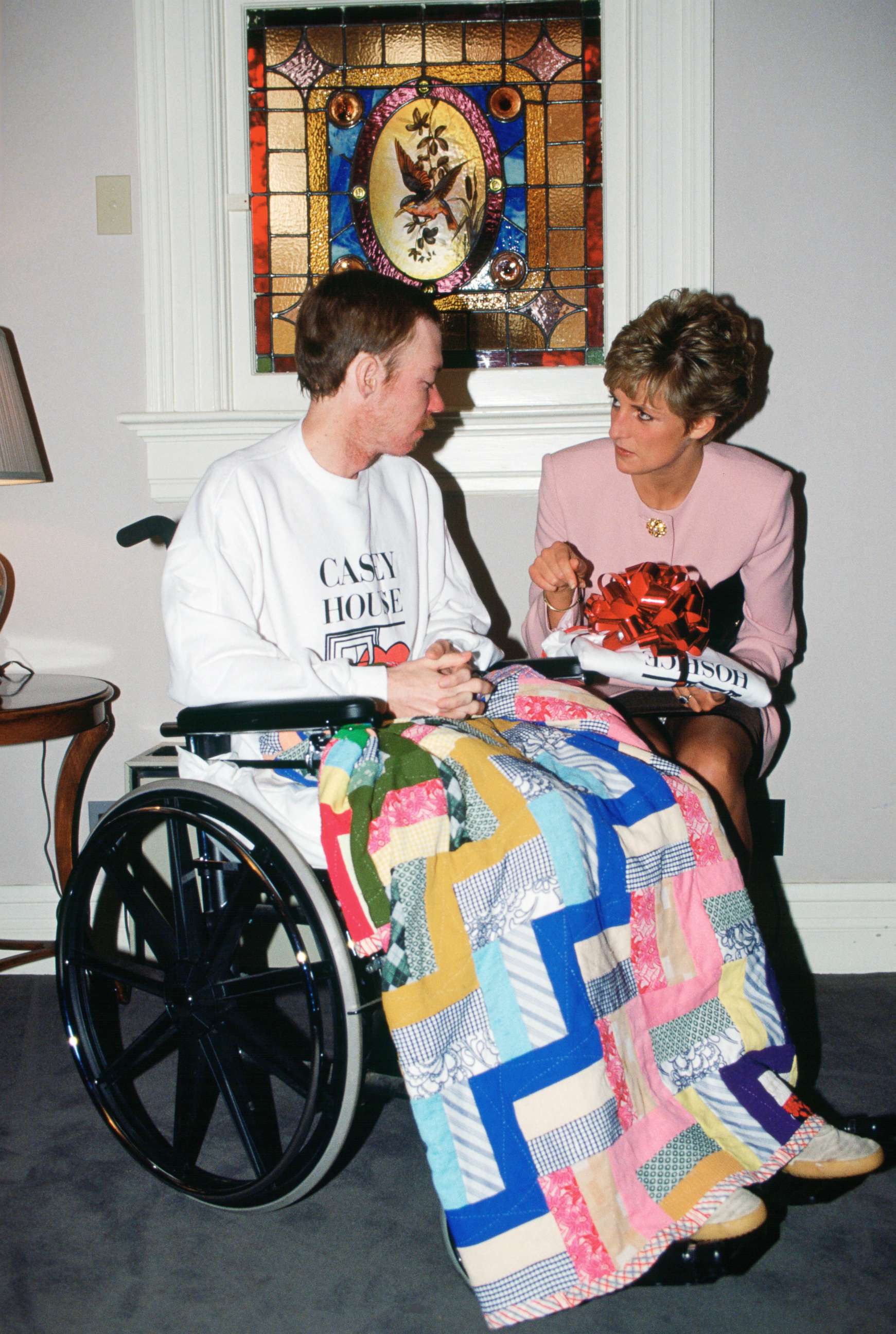 PHOTO: Diana, Princess of Wales sits with one of the residents of Casey House, an AIDS hospice in Toronto, Oct. 25, 1991.
