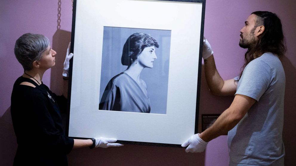 PHOTO: Conservators hang David Bailey's photograph of Diana, Princess of Wales in an undated photo.
