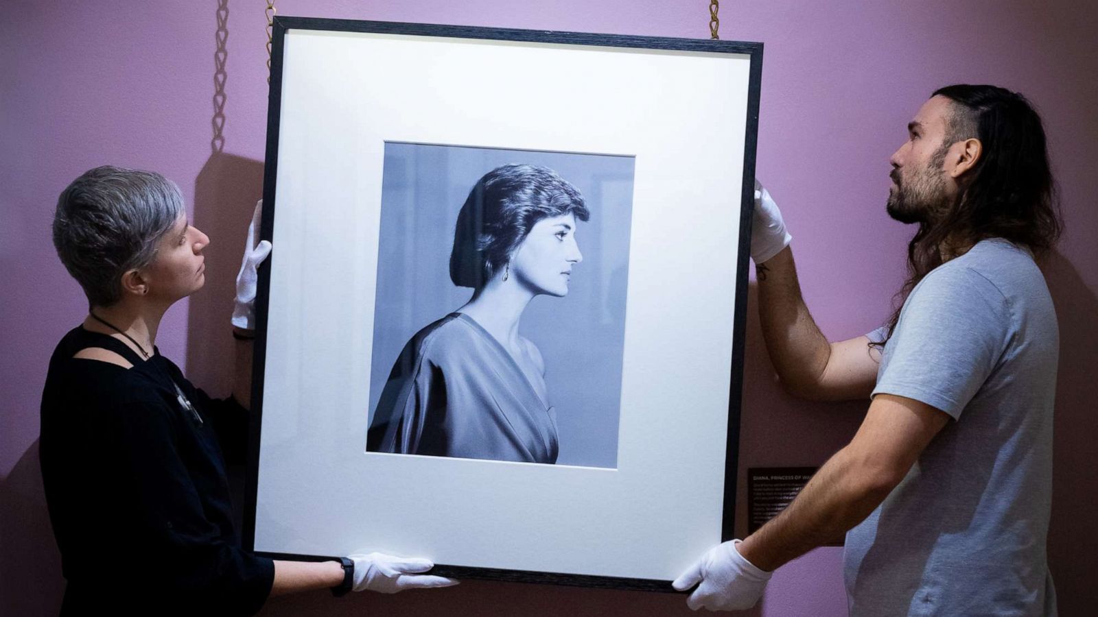 PHOTO: Conservators hang David Bailey's photograph of Diana, Princess of Wales in an undated photo.