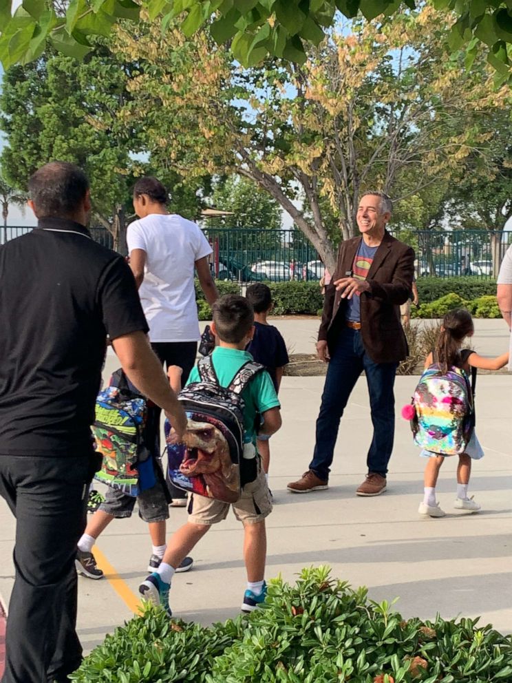 PHOTO: Jeff Sipos kicked off the new school year Aug. 5 by exchanging hugs and high fives with pupils and their families outside John L. Golden Elementary School in Rancho Cucamonga, California. 