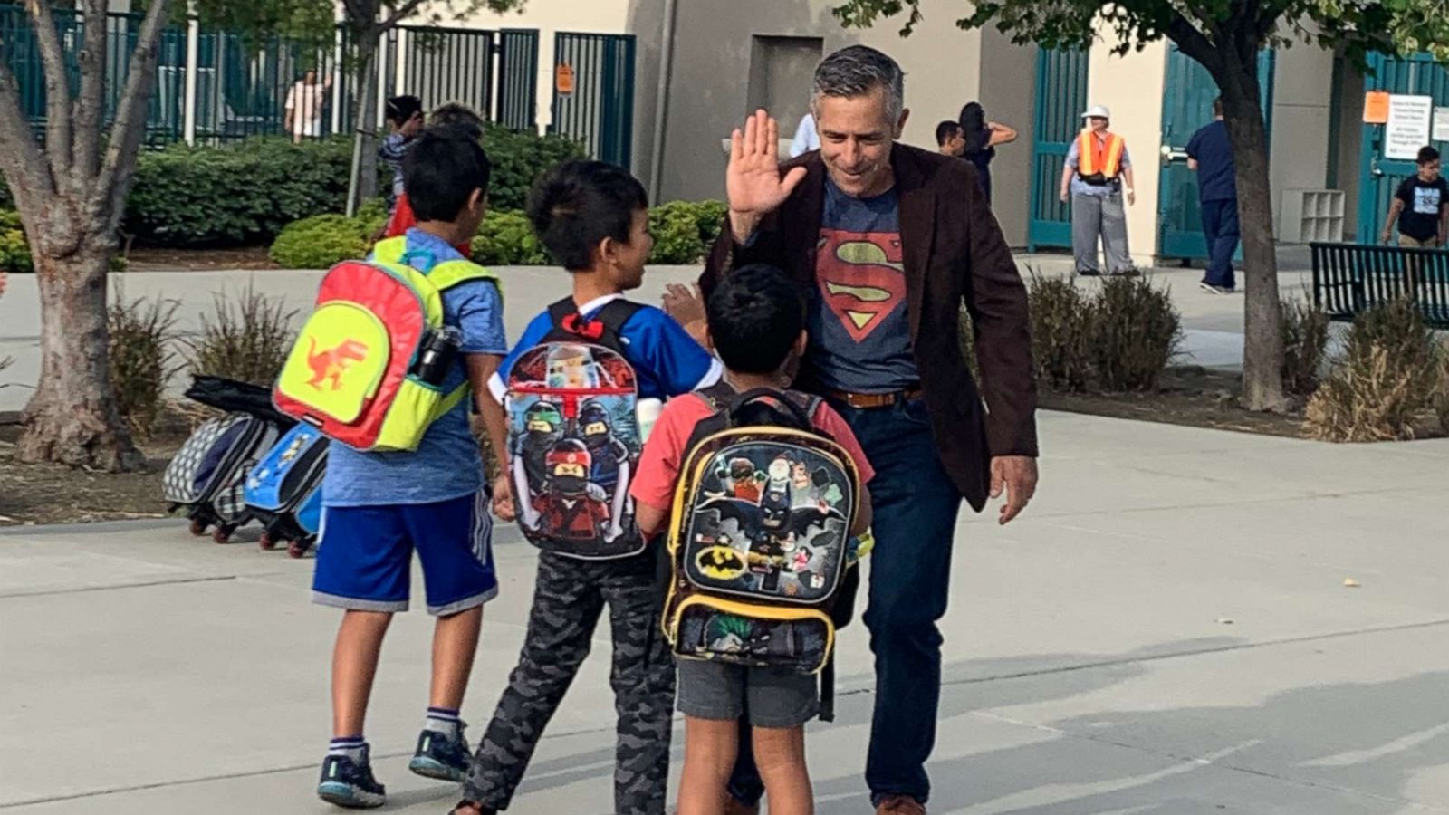 PHOTO: Principal Jeff Sipos kicked off the new school year Aug. 5 by exchanging hugs and high fives with pupils and their families outside John L. Golden Elementary School in Rancho Cucamonga, California.