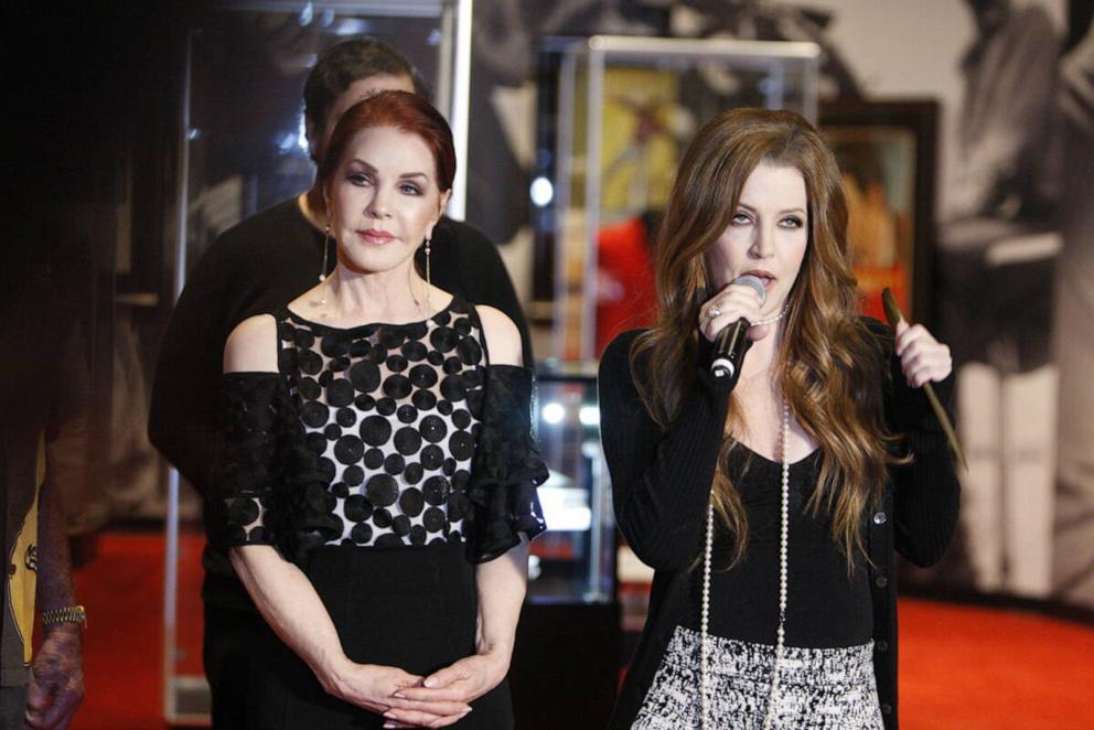 PHOTO: Priscilla Presley, left, listens to her daughter Lisa Marie Presley speak during a media day for "Graceland Presents Elvis: The Exhibition - The Show - The Experience" in Las Vegas, April 23, 2015.