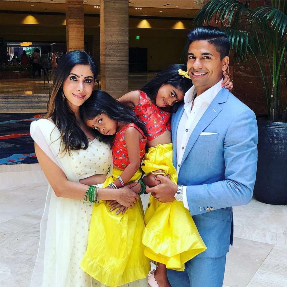 PHOTO: Priya Bhola Rathod, an Indian-American mother of two based in Dallas, Texas, smiles alongside her two daughters and husband. 