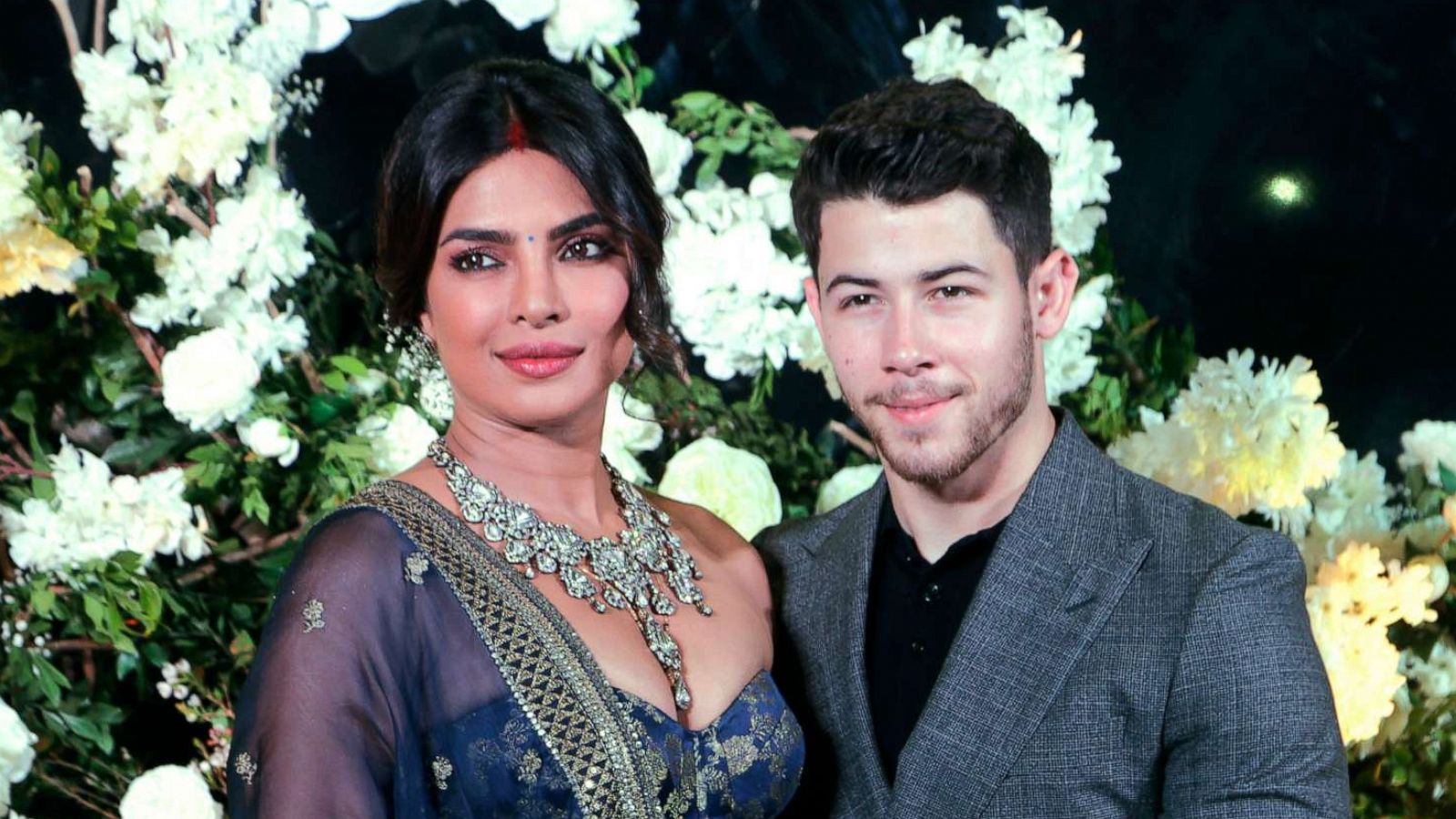 PHOTO: Priyanka Chopra and Nick Jonas stand for photographs at their wedding reception in Mumbai, India, Dec 19, 2018.