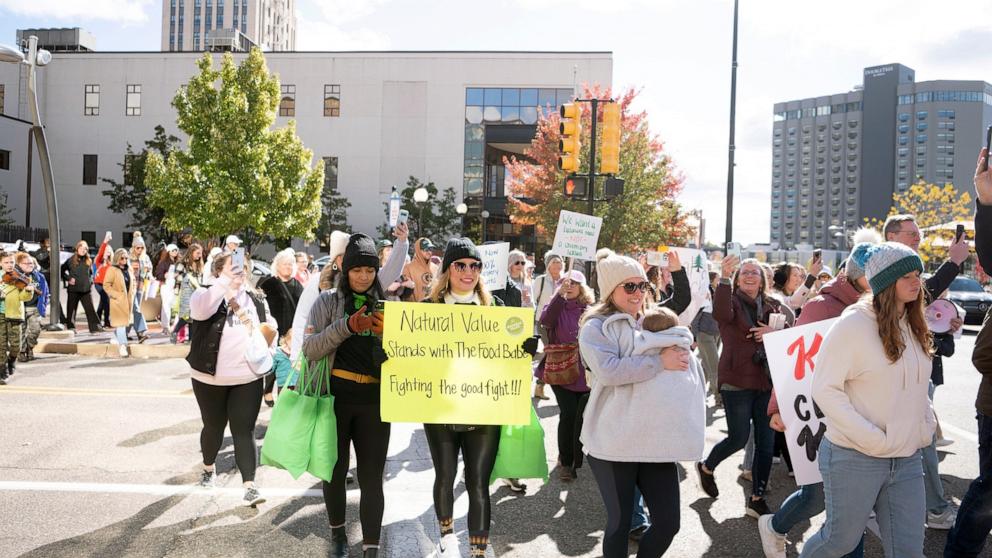 PHOTO: Protesters carry signs through Battle Creek towards Kellogg's headquarters on Oct. 15, 2024