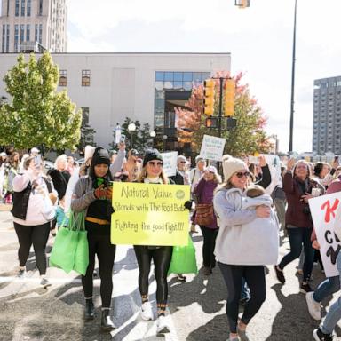 PHOTO: Protesters carry signs through Battle Creek towards Kellogg's headquarters on Oct. 15, 2024