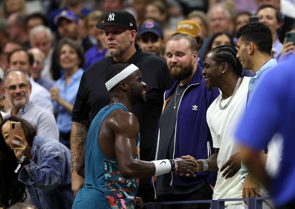 PHOTO: Frances Tiafoe of the U.S. is congratulated by musician Pusha T after winning his second round match against Austria's Sebastian Ofner at the U.S. Open in Flushing Meadows, New York, Aug. 30, 2023.