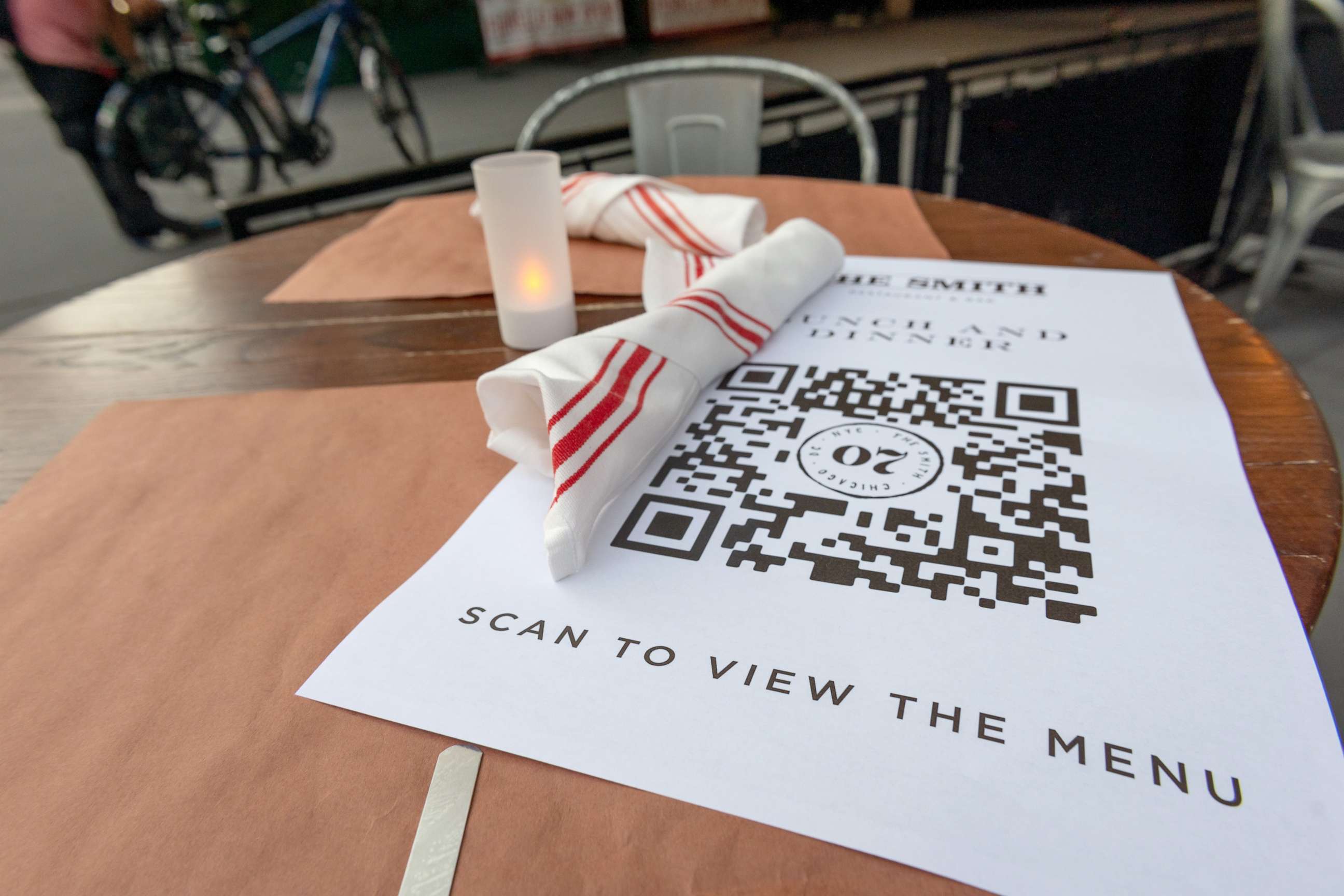 PHOTO: A paper menu with a QR code to encourage touchless ordering is on display at The Smith's outdoor seating near Lincoln Center as New York City moves into Phase 3 of re-opening, on July 13, 2020.