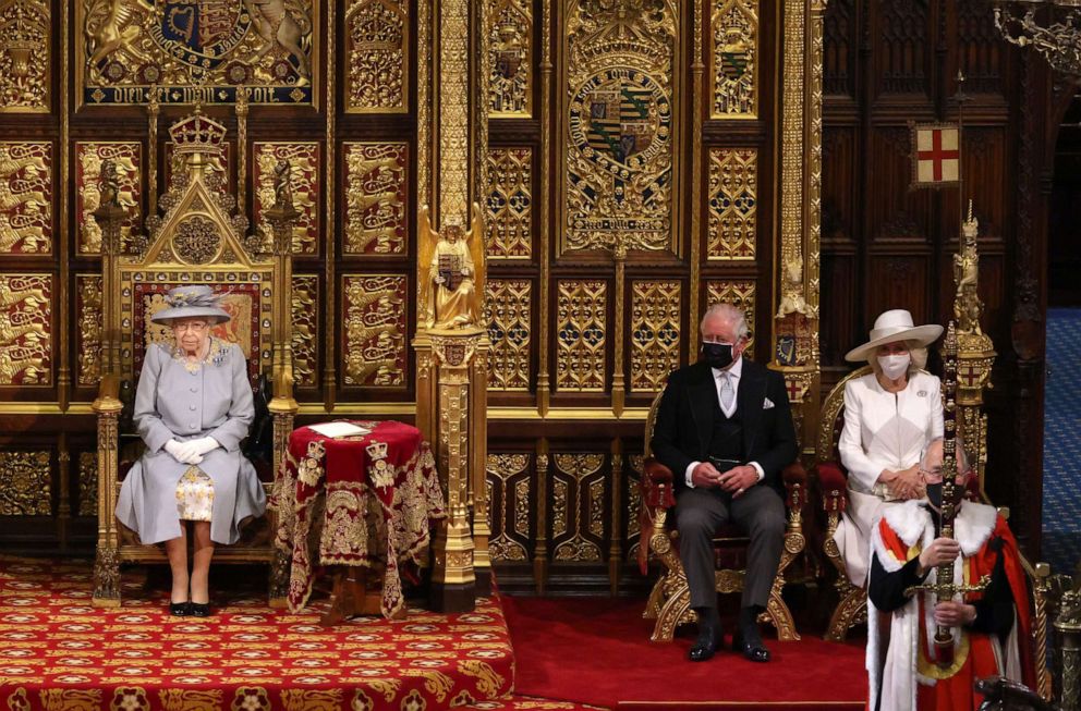 PHOTO: Queen Elizabeth II sits in the House of Lord's Chamber with Prince Charles, Prince of Wales and Camilla, Duchess of Cornwall seated at right during the State Opening of Parliament at the House of Lords on May 11, 2021, in London.