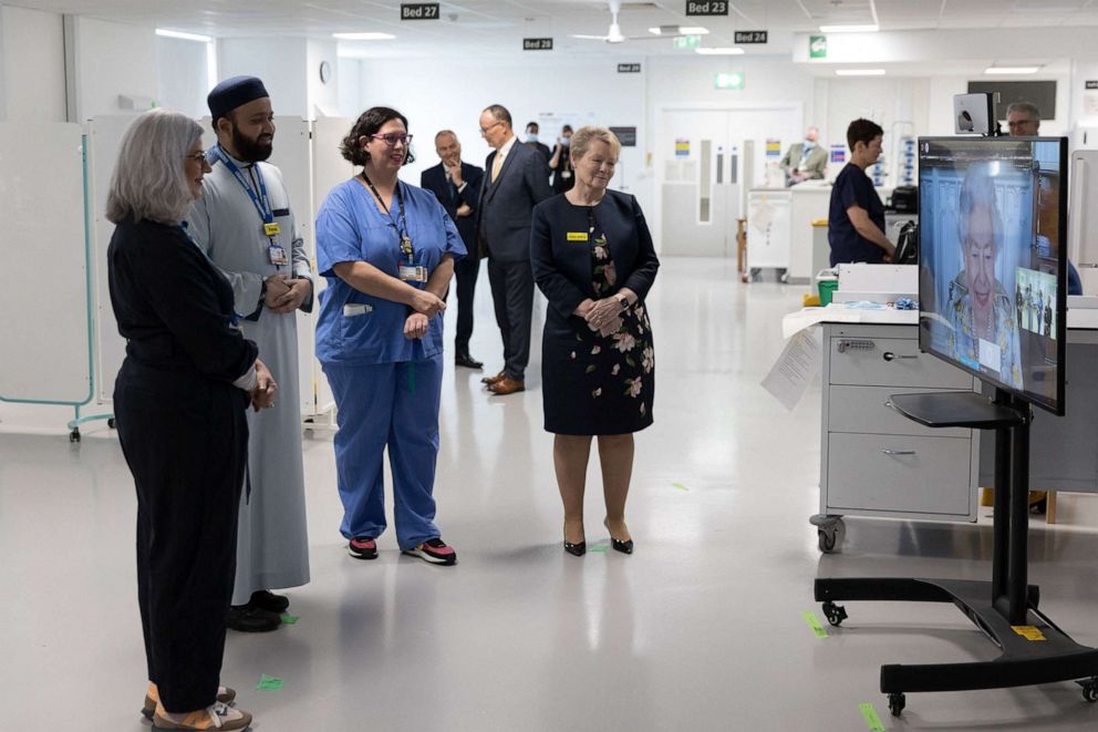 A handout photo released on April 10, 2022, shows staff at The Royal London Hospital in east London during a video call with Britain's Queen Elizabeth II, in residence at Windsor Castle, to mark the official opening of the hospital's Queen Elizabeth Unit.