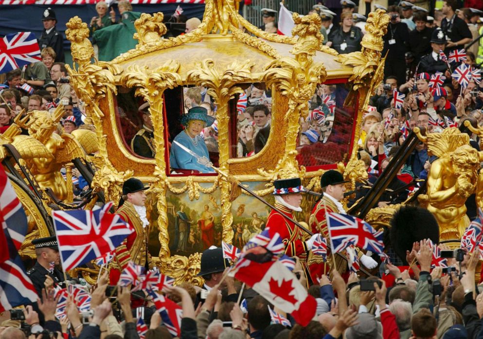 PHOTO: Britain's Queen Elizabeth and Prince Philip ride in the Golden State Carriage at the head of a parade from Buckingham Palace to St Paul's Cathedral celebrating the Queen's Golden Jubilee, on June 4, 2002, in London.