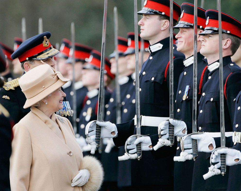 PHOTO: Queen Elizabeth II as proud grandmother smiles at Prince Harry as she inspects soldiers at their passing-out Sovereign's Parade at Sandhurst Military Academy, April 12, 2006, in Surrey, England.