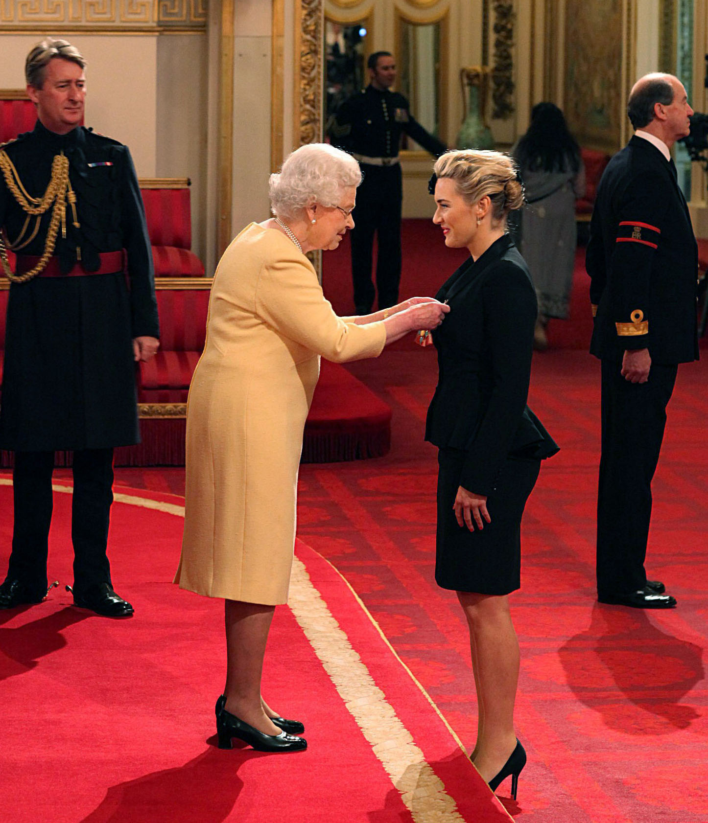 FILE PHOTO: Queen Elizabeth II awards British actress Kate Winslet a CBE (Commander of the Most Excellent Order of the British Empire) for services to drama, during an Investiture ceremony at Buckingham Palace in central London, U.K., Nov. 21, 2012.