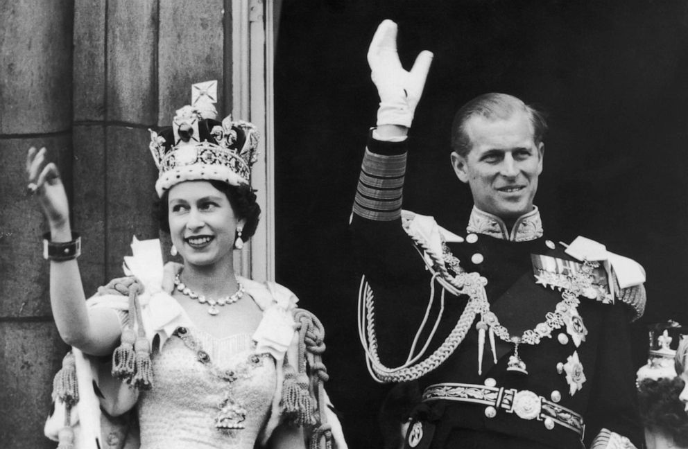 PHOTO: Queen Elizabeth II and the Duke of Edinburgh wave at the crowds from the balcony at Buckingham Palace after Elizabeth's coronation, June 2, 1953, in London.