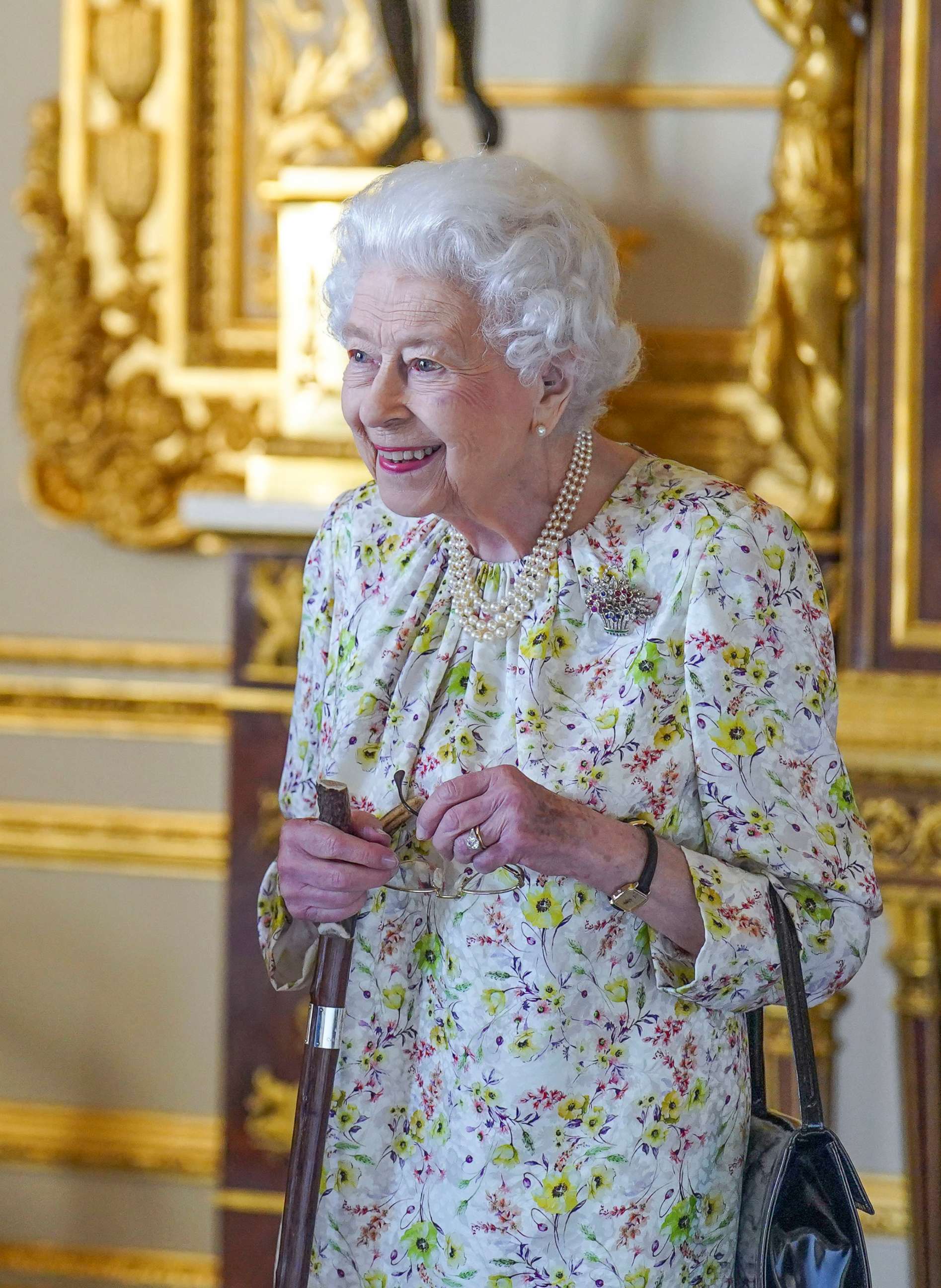 PHOTO: Queen Elizabeth II arrives to view a display of artefacts from British craftwork company, Halcyon Days, to commemorate the company's 70th anniversary in the White Drawing Room at Windsor Castle, on March 23, 2022 in Windsor, England.
