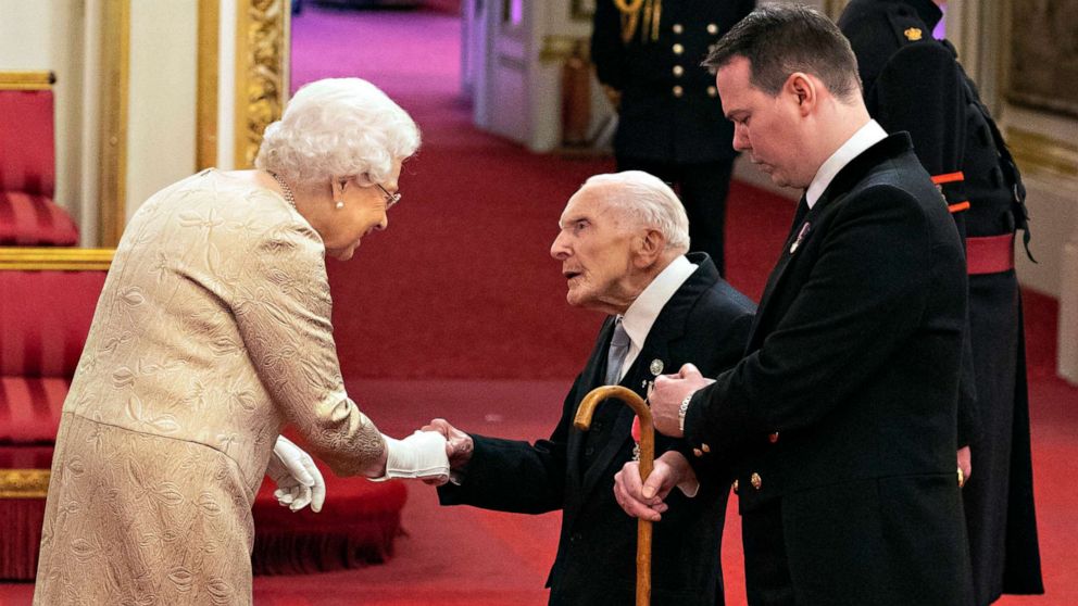 PHOTO: Queen Elizabeth wears gloves as she awards the MBE (Member of the Order of the British Empire) to Harry Billinge from St Austell, during an investiture ceremony at Buckingham Palace in London, March 3, 2020.