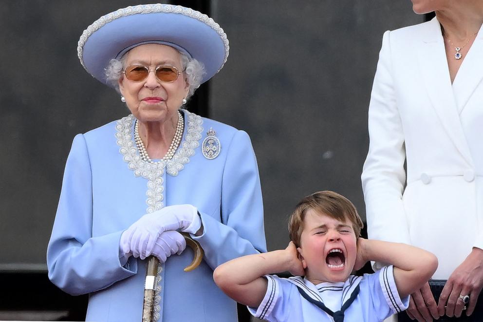 PHOTO: Prince Louis of Cambridge holds his ears as he stands next to Britain's Queen Elizabeth II to watch a special flypast from Buckingham Palace balcony, as part of Queen Elizabeth II's platinum jubilee celebrations, in London, on June 2, 2022. 