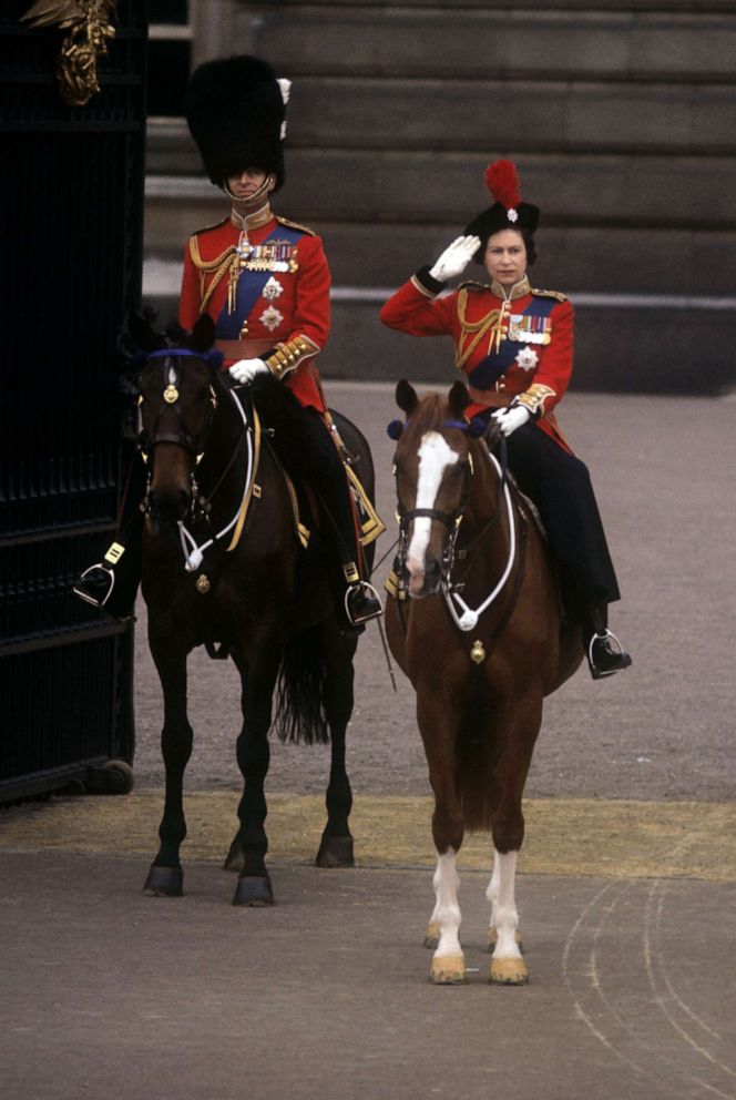 PHOTO: Queen Elizabeth II, accompanied by the Duke of Edinburgh, takes the salute outside Buckingham Palace at the conclusion of the Trooping the Colour ceremony, June 13, 1964.