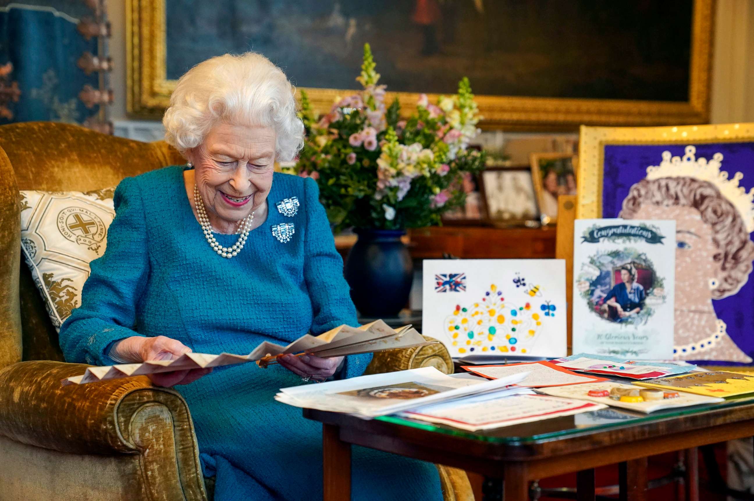 PHOTO: A picture released in London on Feb. 4, 2022, and taken last month shows Britain's Queen Elizabeth II as she views a display of memorabilia from her Golden and Platinum Jubilees in the Oak Room at Windsor Castle.