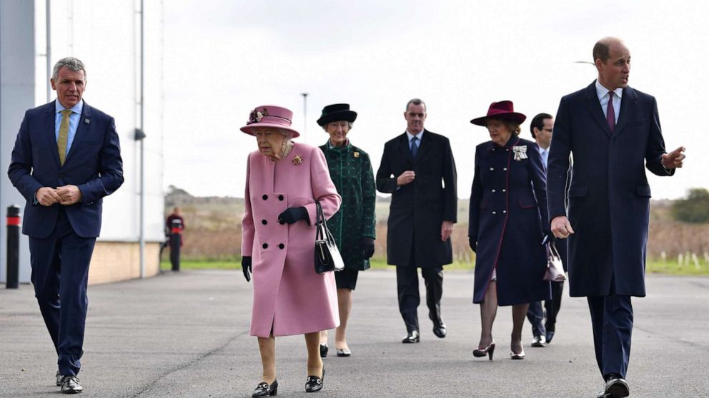 PHOTO: Britain's Queen Elizabeth II (C) and Britain's Prince William, Duke of Cambridge (R) arrive with Dstl Chief Executive Gary Aitkenhead (L) at Porton Down science park near Salisbury, southern England, on Oct. 15, 2020.