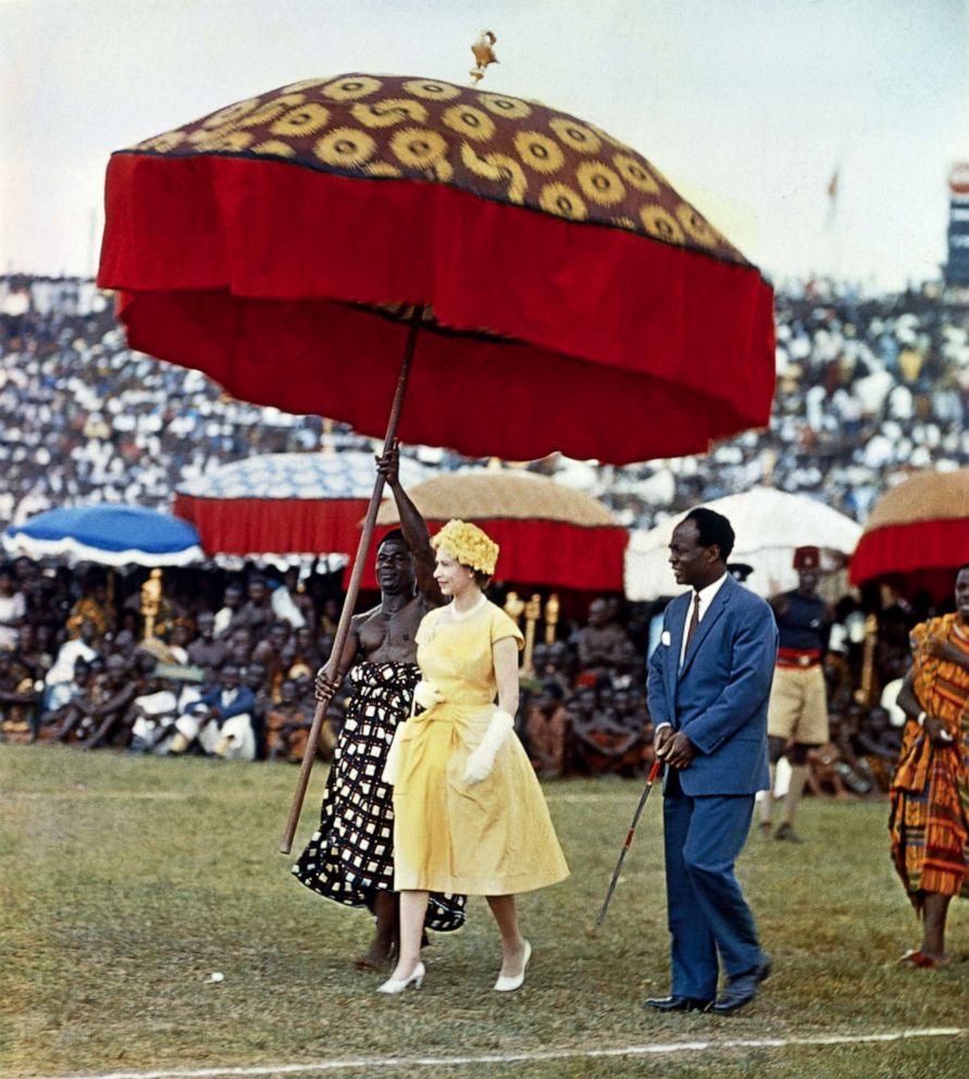 PHOTO: Queen Elizabeth II makes her way underneath a large, colored umbrella, to a dais to watch the Durbar of the Ashanti Chiefs, at Kumasi Sports Stadium in Ghana, Nov. 15, 1960.