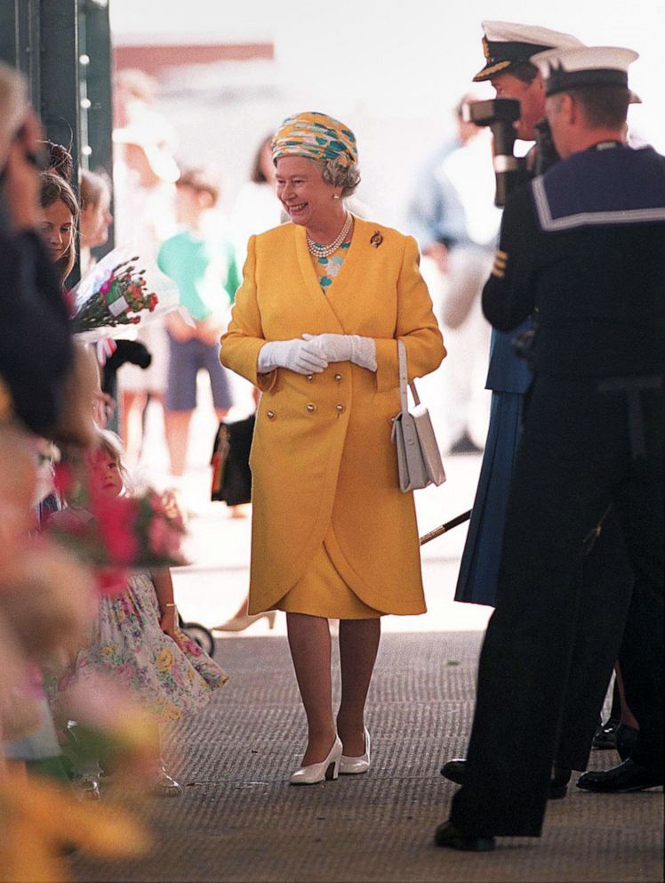 PHOTO: Queen Elizabeth II greets people on her way to board the yacht Britannia for a cruise, Aug. 7, 1996, in Portsmouth, England.