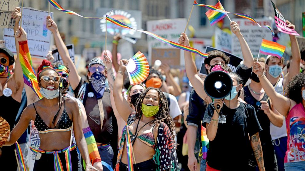 PHOTO: Marchers are seen smiling and waving during the Queer Liberation March for Black Lives & Against Police Brutality on June 28, 2020 in New York City.