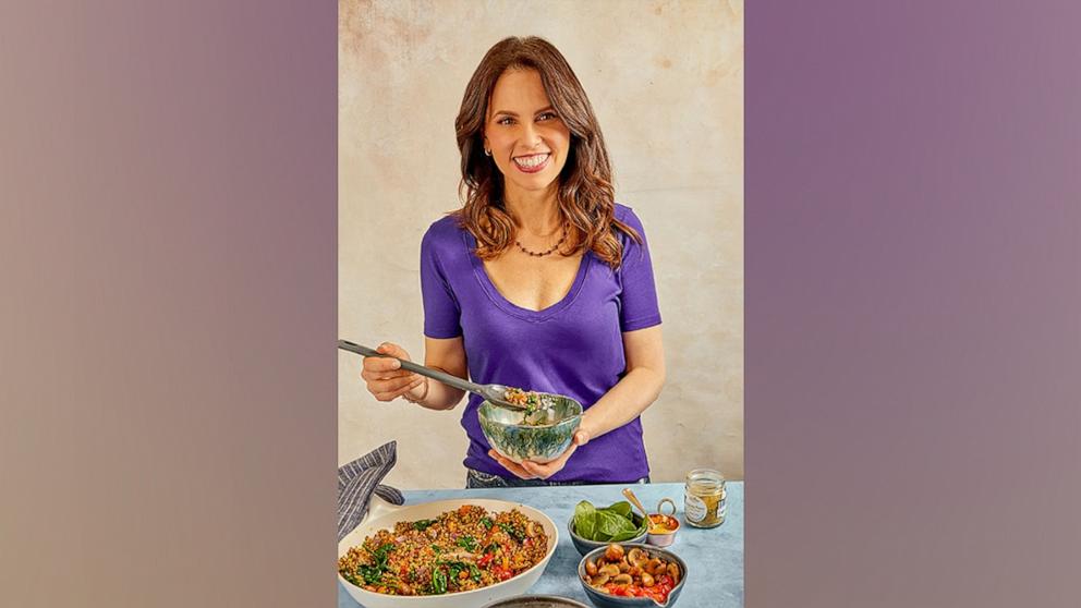 PHOTO: Dietitian Rachel Beller holds a bowl of grain salad. 