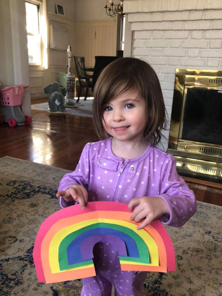 PHOTO: Charlotte Cunningham, 2, holds a rainbow she created to spread hope and joy in her Long Island, New York, community amid the coronavirus crisis.