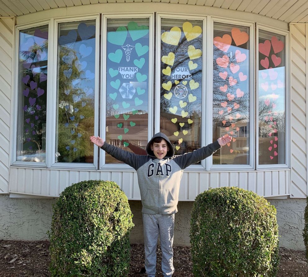 PHOTO: Michael, 9, stands in front of a rainbow he created to spread hope and joy in his Long Island, New York, community amid the coronavirus crisis.