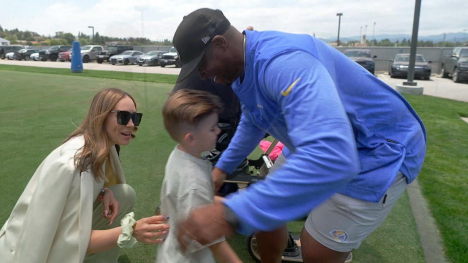 PHOTO: Los Angeles Rams defensive coordinator Raheem Morris reunites with Wyatt Stanley, whose life he helped save.