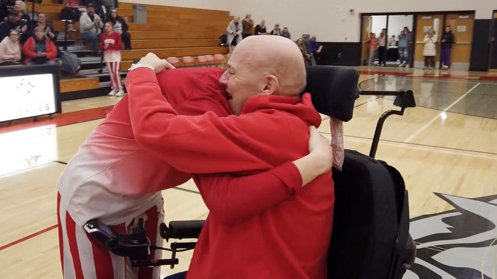 PHOTO: Randy Knecht greeted his daughter on the court after surprising her at Parent's Night at Cochrane-Fountaine City school in Fountain City, Wis.