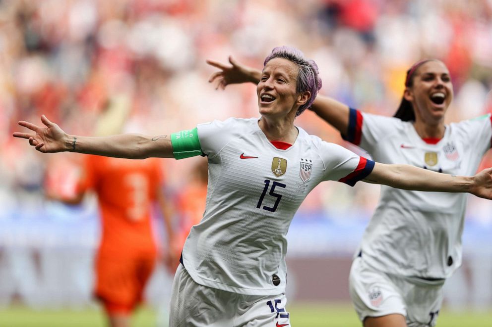 PHOTO:Megan Rapinoe of the USA celebrates scoring the first goal from the penalty spot with Alex Morgan during the 2019 FIFA Women's World Cup France Final match between The United State of America and The Netherlands at Stade de Lyon on July 07, 2019.