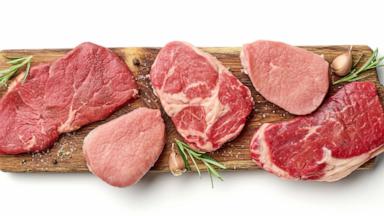 PHOTO: Various types of steak on wooden board isolated on white, from above