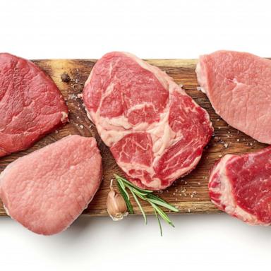 PHOTO: Various types of steak on wooden board isolated on white, from above