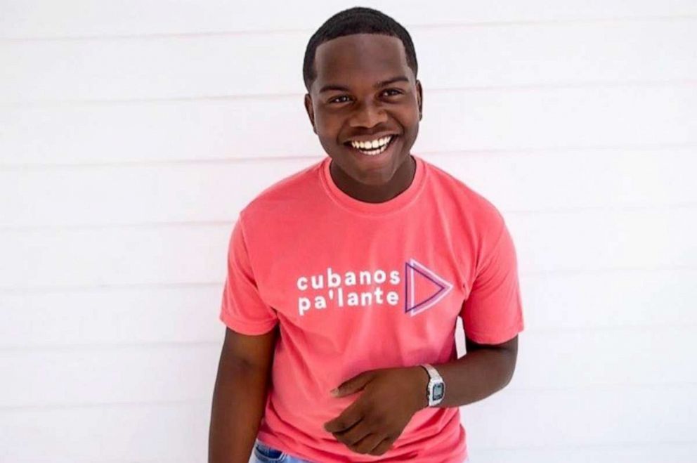 PHOTO: Raymond Adderly smiles while wearing the shirt, "Cubanos Pa'lante."