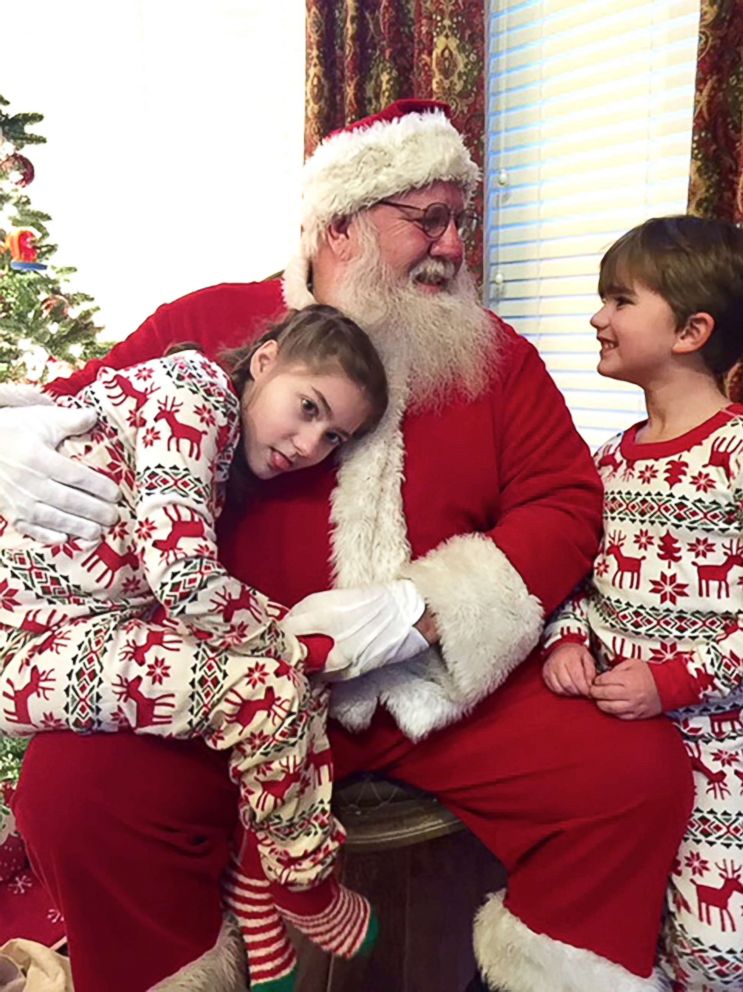 PHOTO: Reagan and Ryan Guidryvi sit with Santa in 2017.