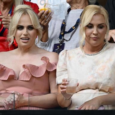 PHOTO: Rebel Wilson (L) and wife Ramona Agruma watch the Women's Singles First Round match during day one of the 2025 Australian Open at Melbourne Park on January 12, 2025 in Melbourne, Australia.