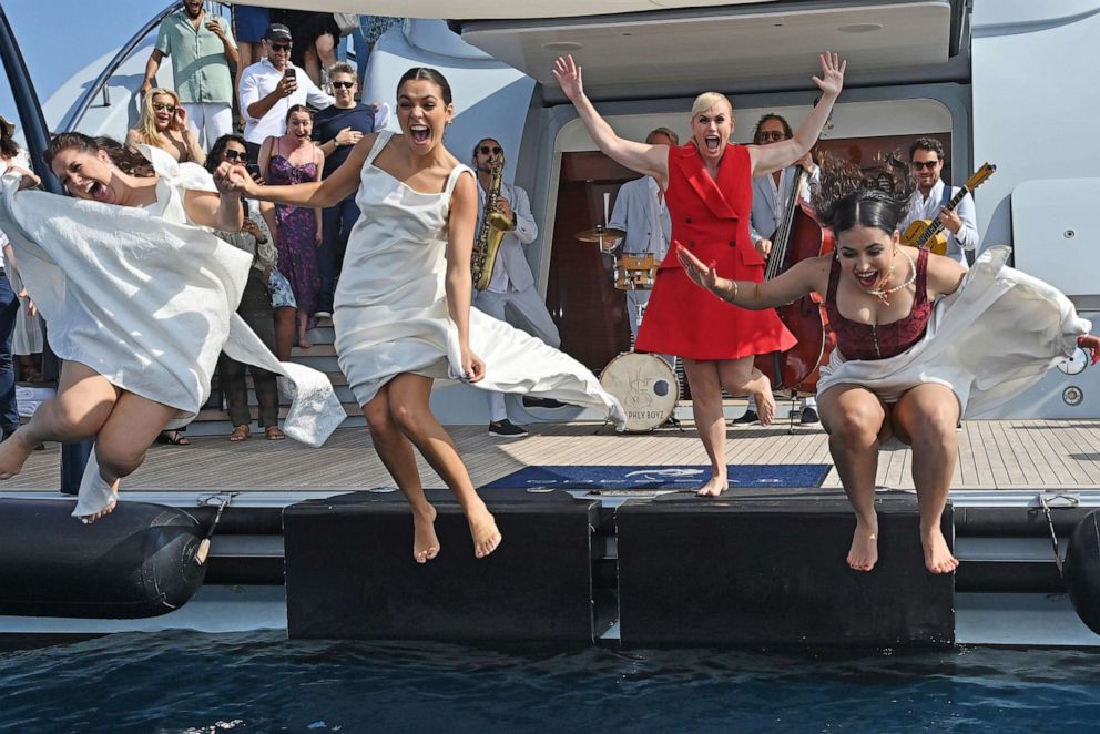 PHOTO: Rebel Wilson stays behind as cast members jump into the sea at a party to celebrate the launch of Rebel's forthcoming film and directorial debut "The Deb" during the 76th Cannes Film Festival on May 24, 2023 in Cannes, France.