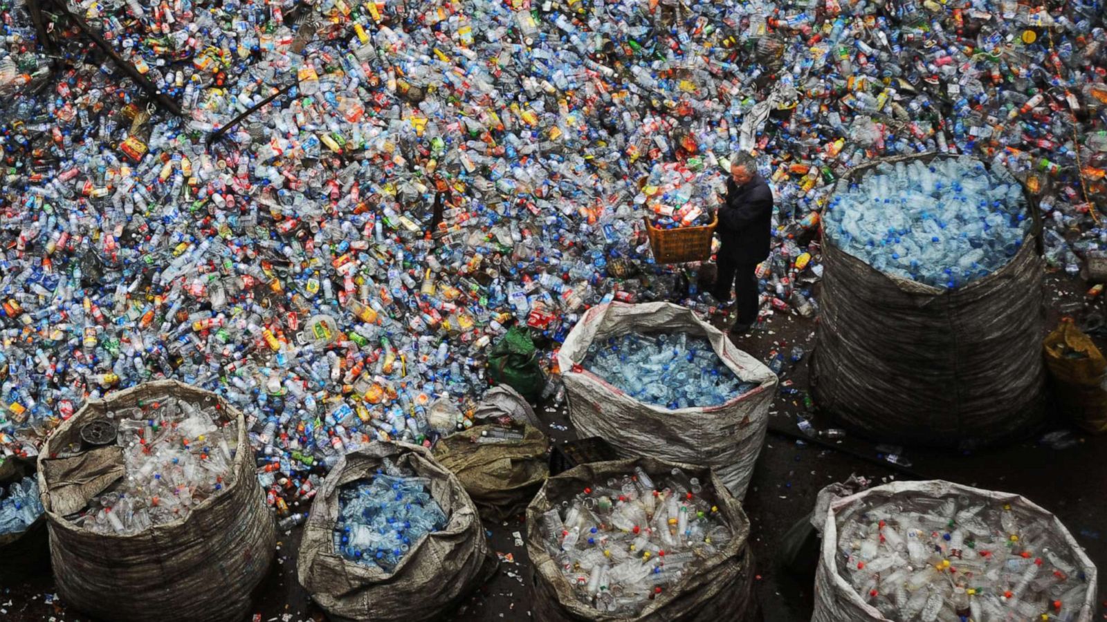 PHOTO: A worker sorts used plastic bottles at a plastics recycling mill which is ceasing production, Oct. 29, 2008 in Wuhan, China.