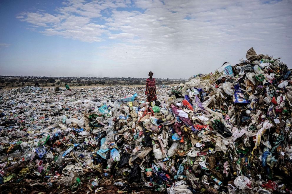 PHOTO: A recycler stands among a tons of plastic rubbish at a sanitary landfill on June 2, 2018, in the industrial city of Bulawayo, Zimbabwe.