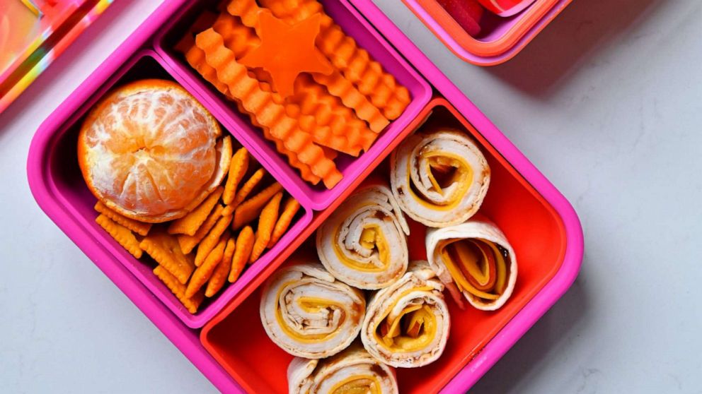 PHOTO: A kids' lunchbox with fun snacks and a red and orange color scheme.