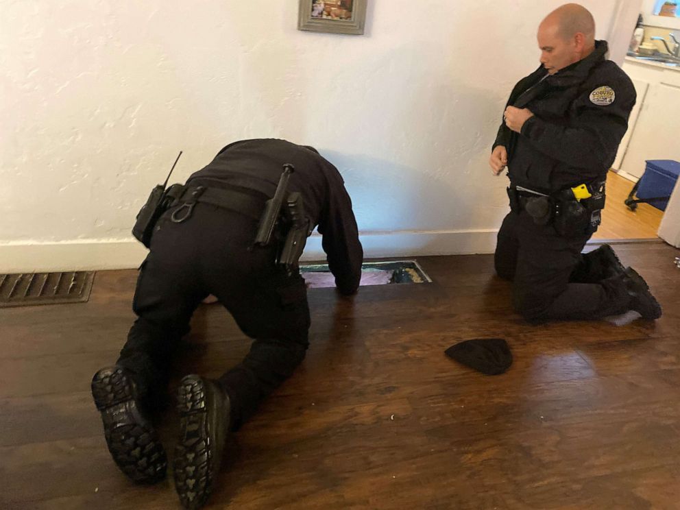 PHOTO: Police officers in Oregon look in a heating vent that a 10-month-old baby fell through.